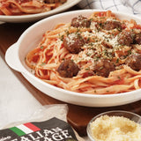 A plate of pasta topped with bite-sized sausage pops and grated cheese.