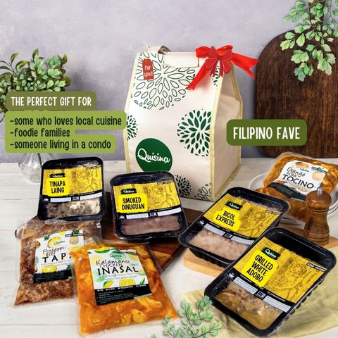 A gift set featuring various packaged food items including Tocino, Tapa, Inasal, Smoked Dinuguan, Bicol Express, Tinapa Laing, and Adobo, presented in a thermal bag with a red ribbon on top.