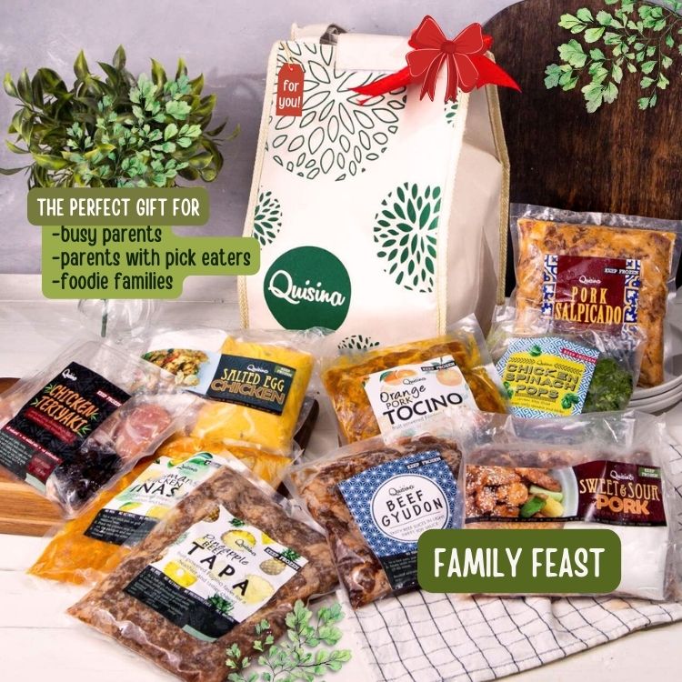 A gift set from Quisina titled 'Family Feast' featuring various packaged food items including teriyaki chicken, beef gyudon, pork salpicado, tocino, pineapple beef tapa, and salted egg chicken, presented in a thermal gift bag with a red ribbon on top.