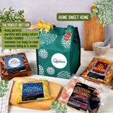 The image shows a green thermal gift bag branded 'quisina' with the text 'Home Sweet Home' and various food items arranged around it, including teriyaki chicken, beef gyudon, pork salpicado, and herbed Dijon chicken, indicating the gift set contents.